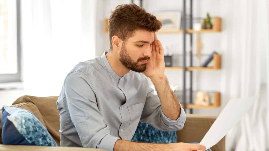 Unhappy Man with Bills or Tax Report