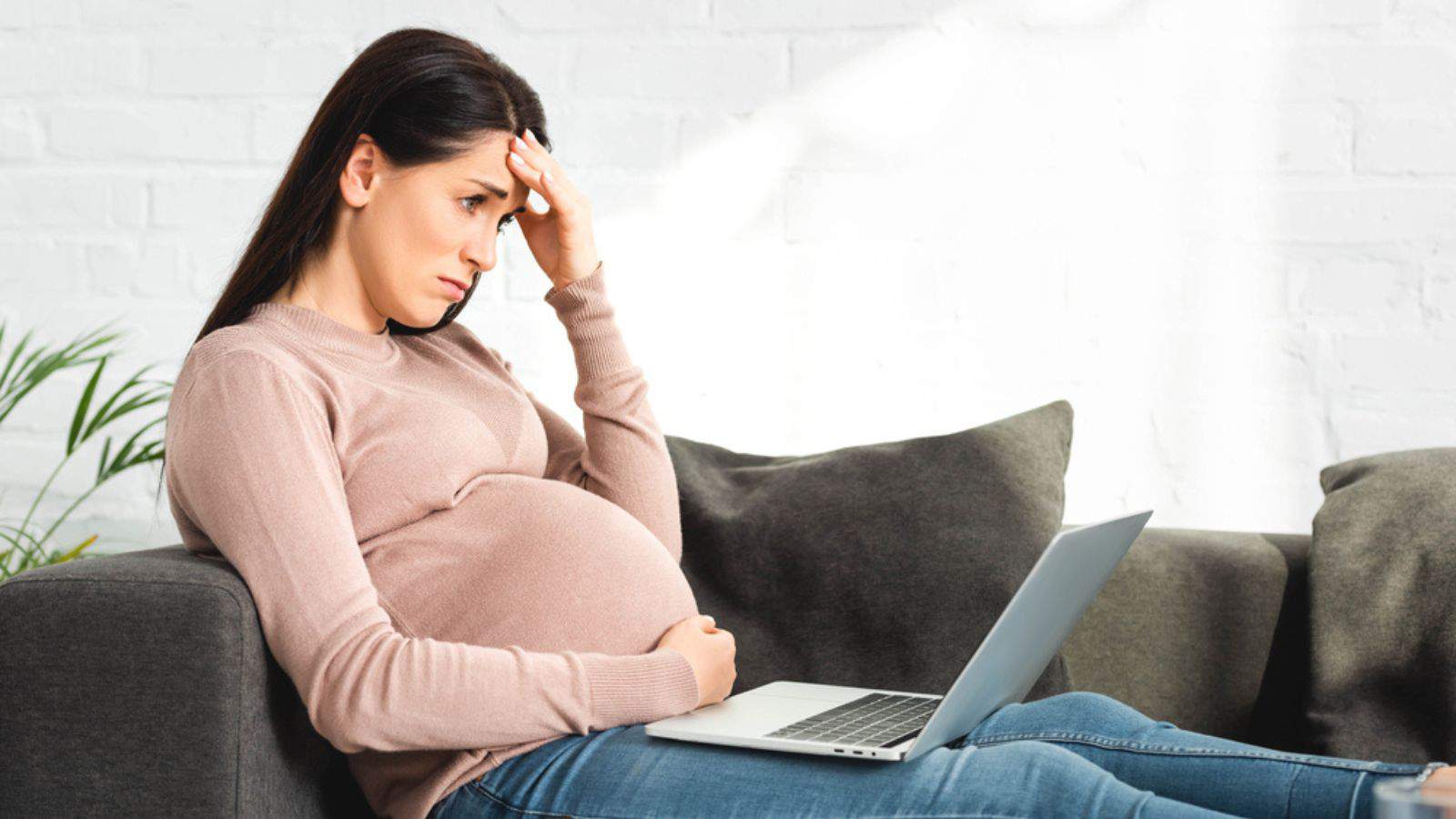 Upset pregnant woman having online consultation with doctor