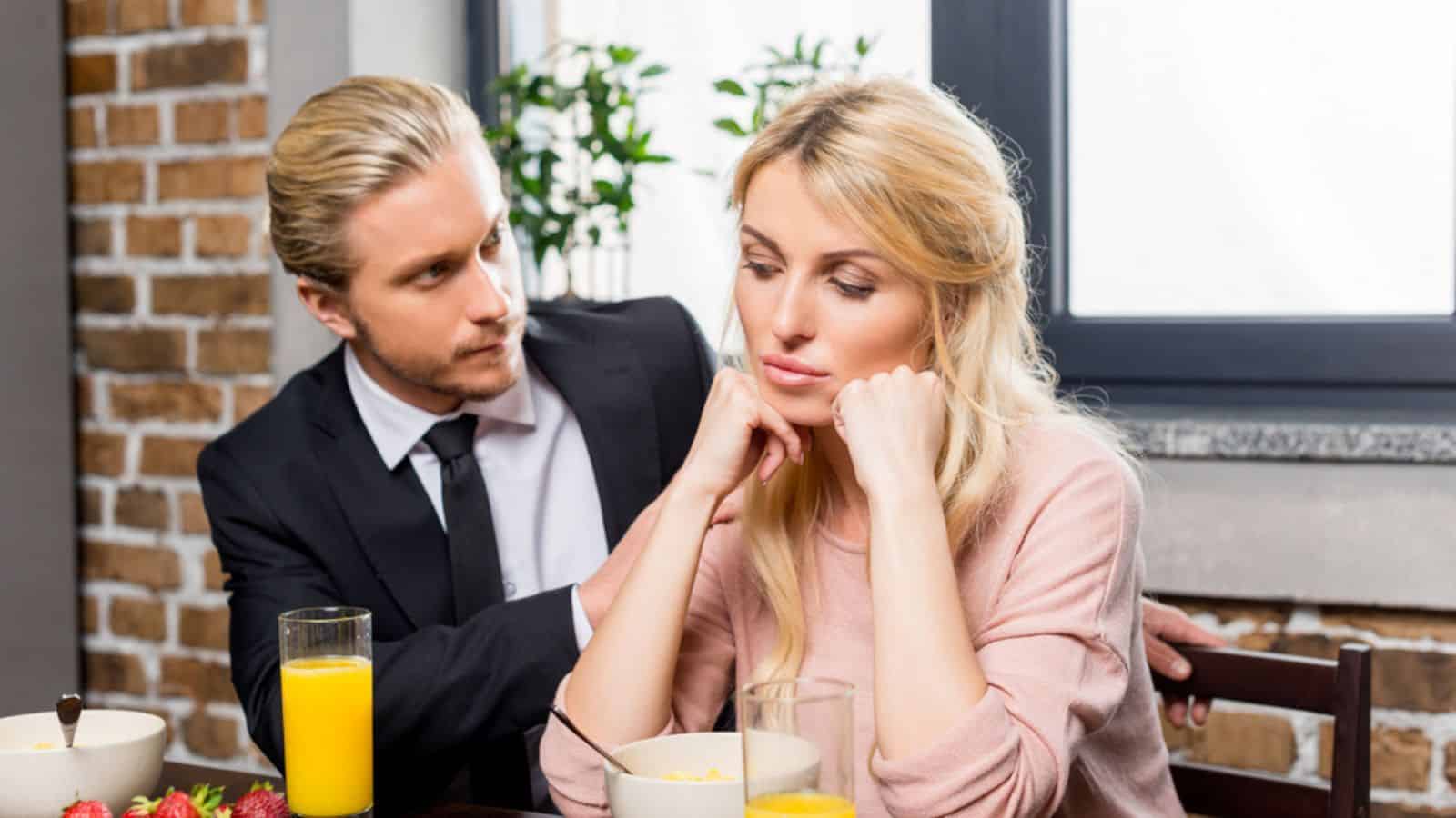 Upset woman with husband during breakfast