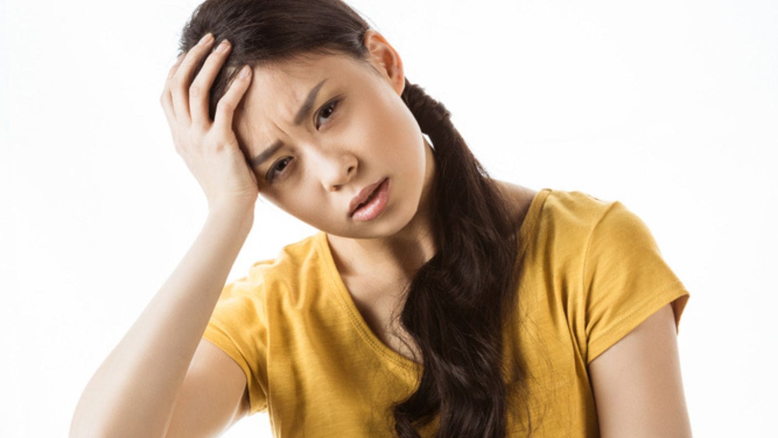 Upset young asian girl with headache
