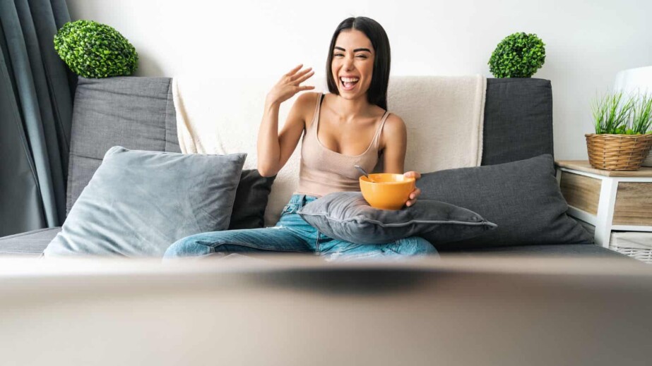 Woman Eating Breakfast While Watching TV