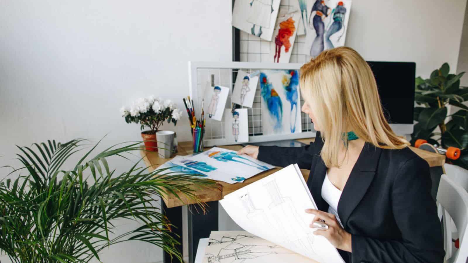 Woman Fashion designer working with sketches