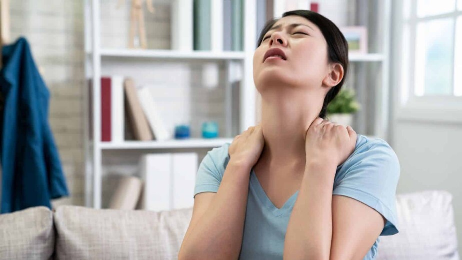 Woman Has Neck Pain Stretching