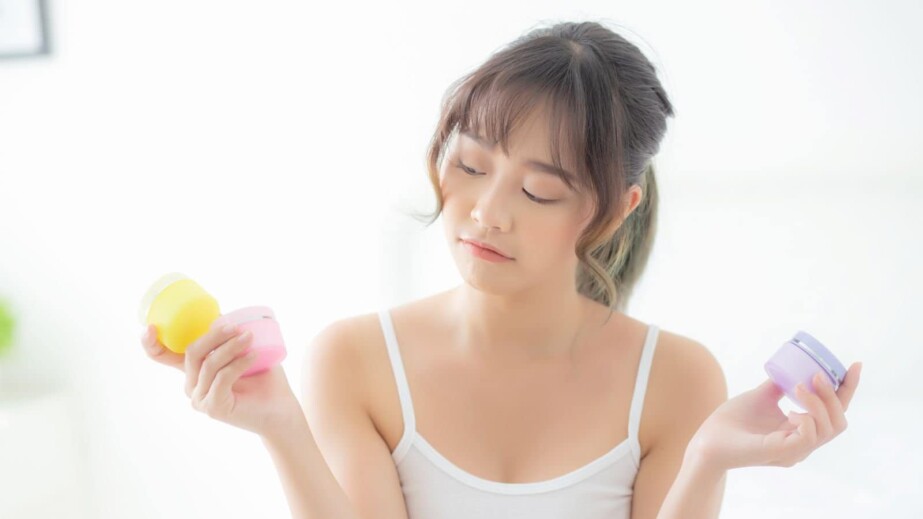 Woman Holding Skincare Products