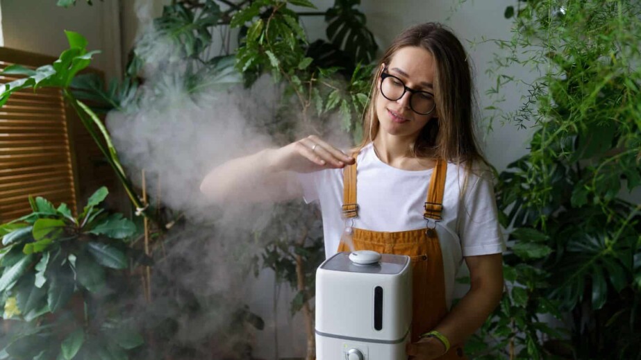 Woman Using a Humidifier in the Garden