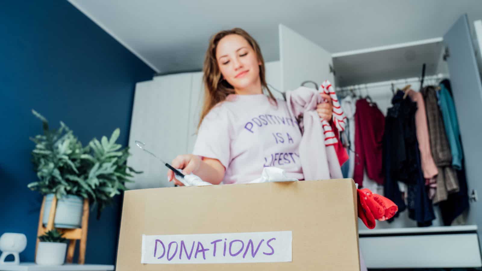 Woman decluttering clothes for donation