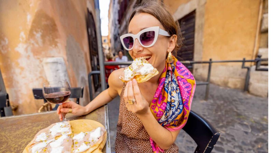 Woman eating pizza at Italian restaurant
