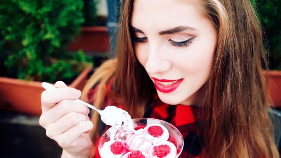 Woman in Red Eating Dessert