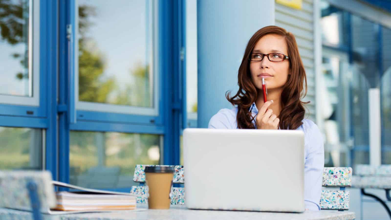 Woman thinking outdoor using laptop