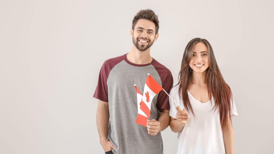 Young People with Canadian Flags on Light Background