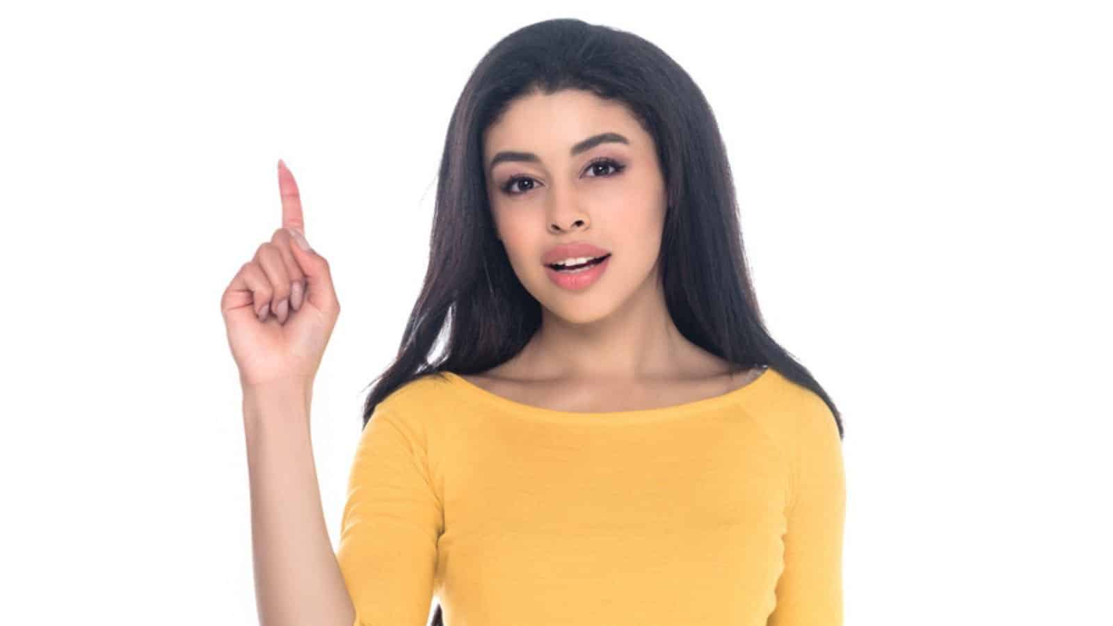 Young african american woman pointing up with finger