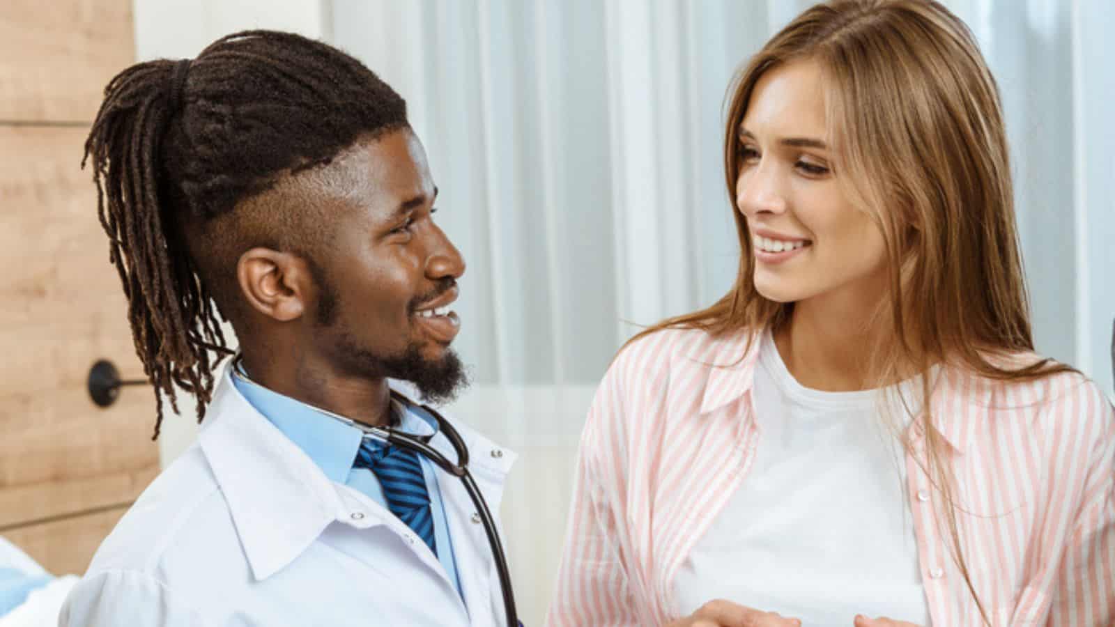 Young doctor talking to woman