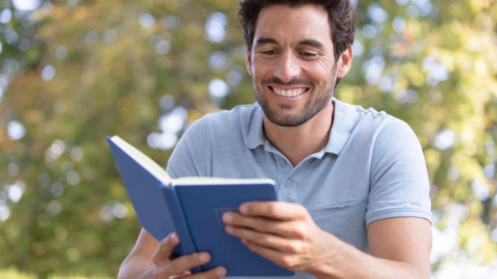 Young man traveler reading a book