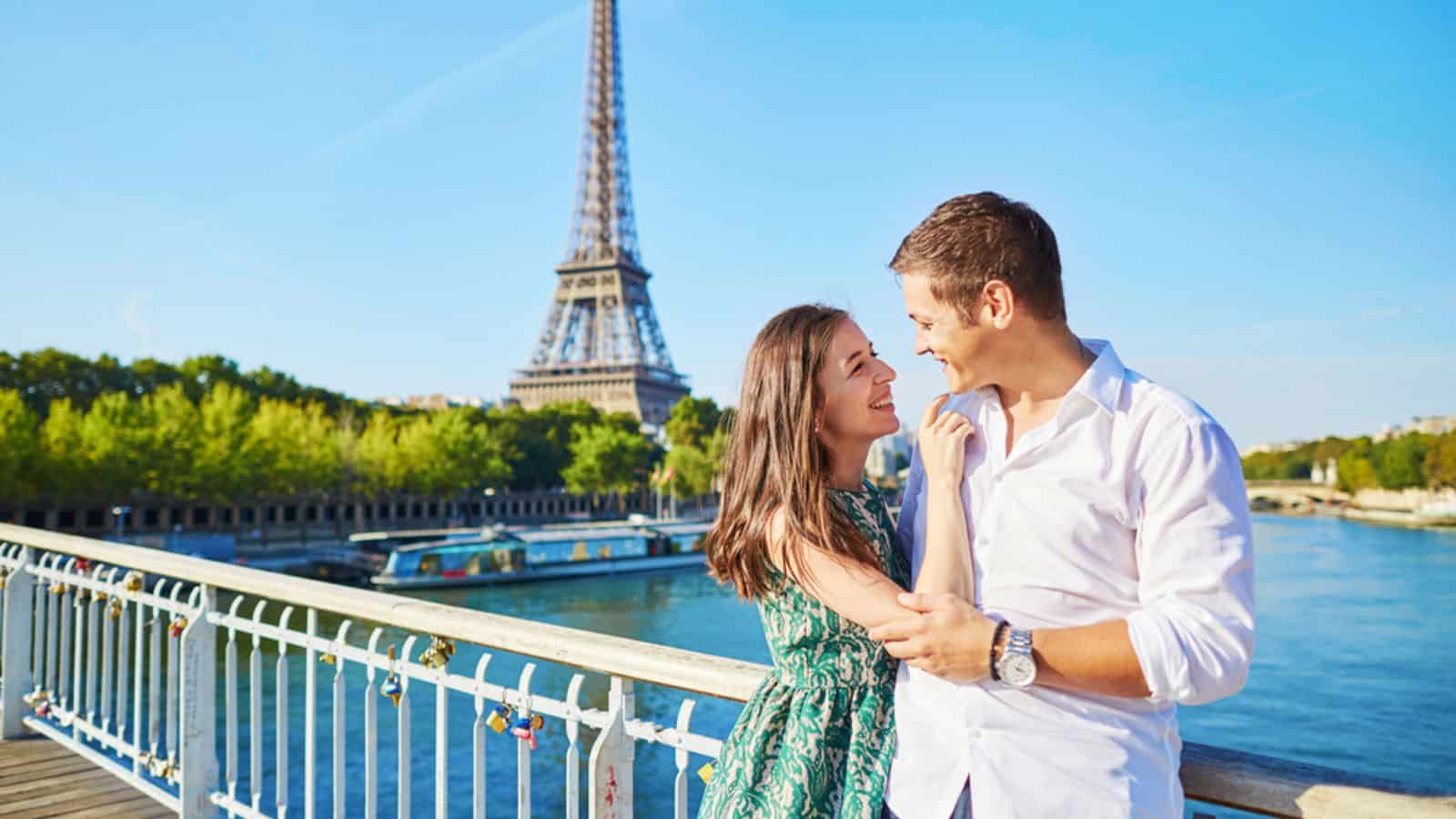 Young romantic couple having a date near the Eiffel tower Paris