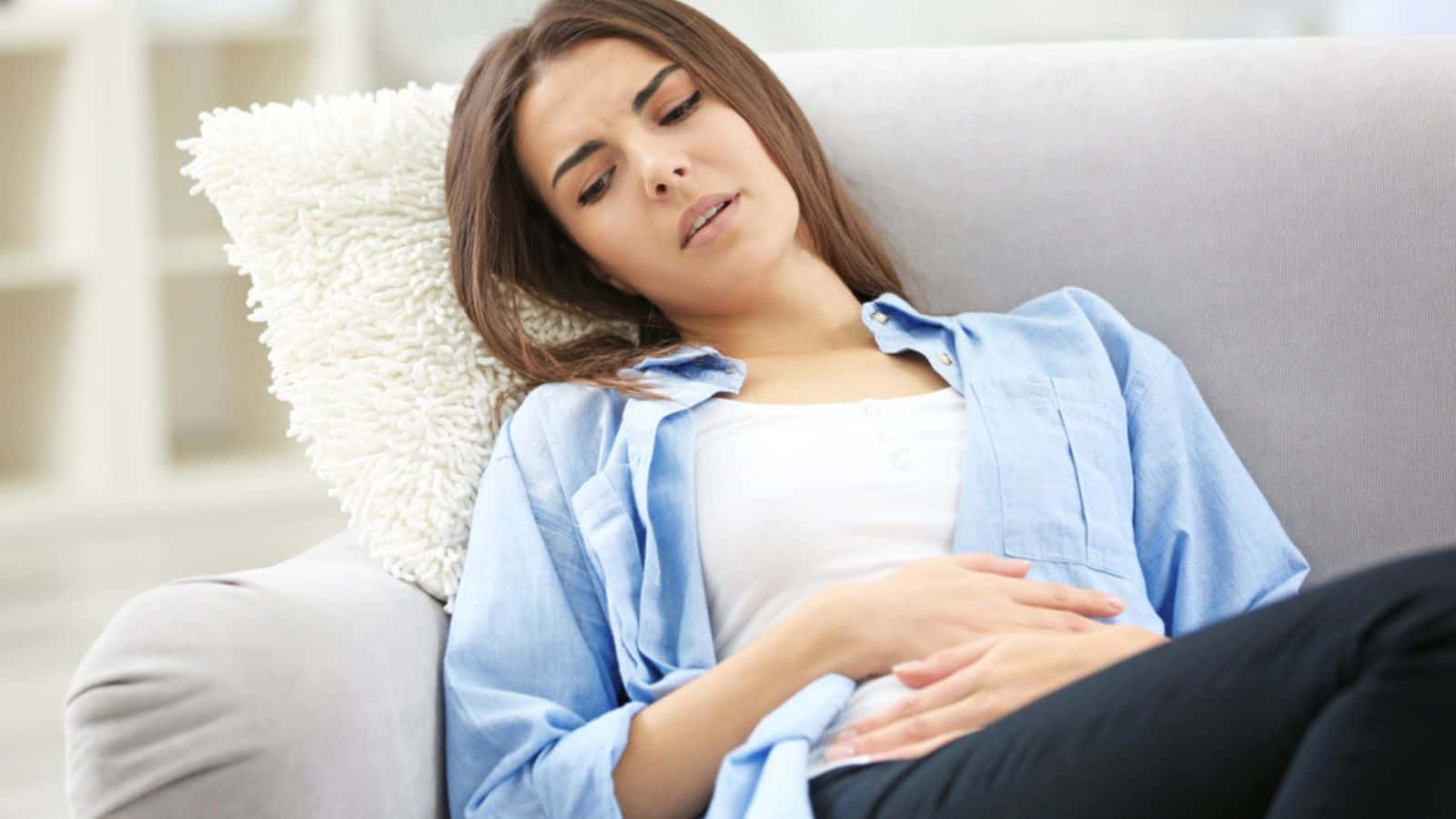 Young woman suffering from abdominal pain