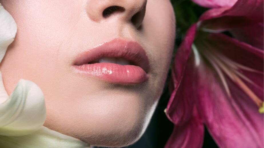 beautiful young woman with pink lips and lilium flowers