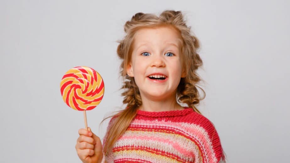 child with a Lollipop on a stick smiling