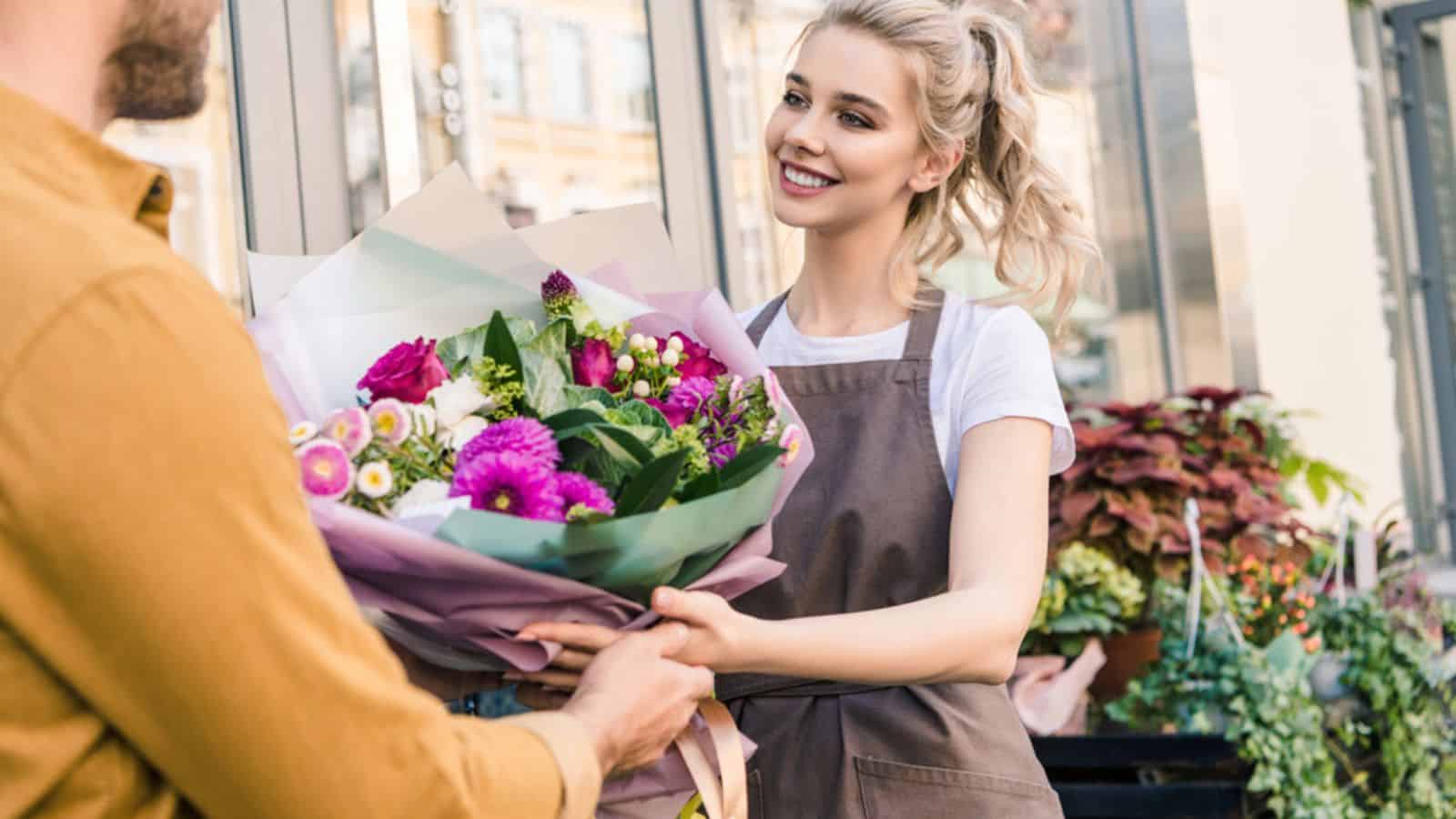 man giving bondle of flowers to beautiful girl