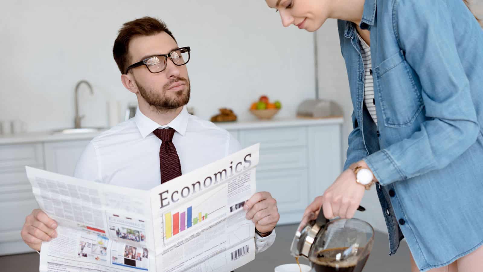 man reading news woman pouring coffee