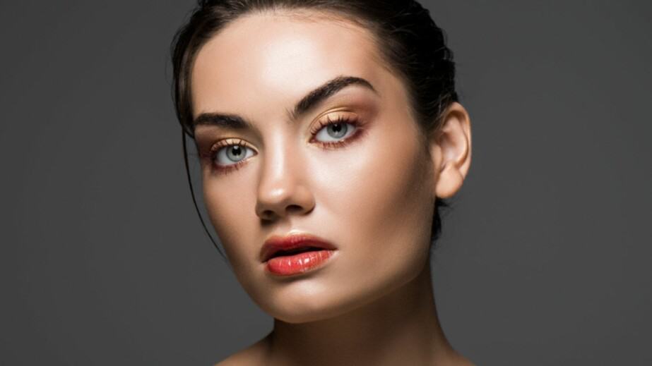  model with makeup posing isolated on grey