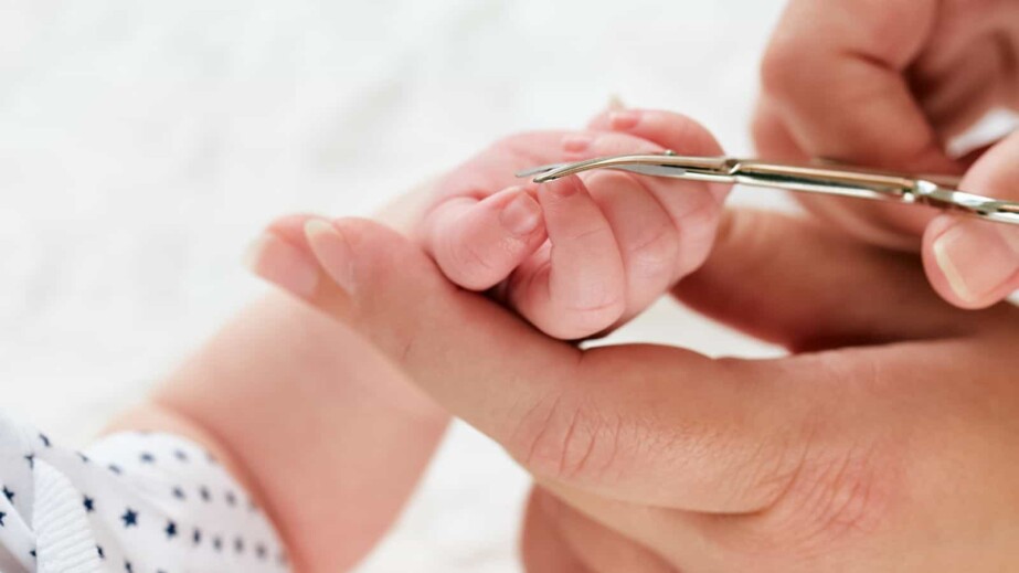 mother cutting baby's nails